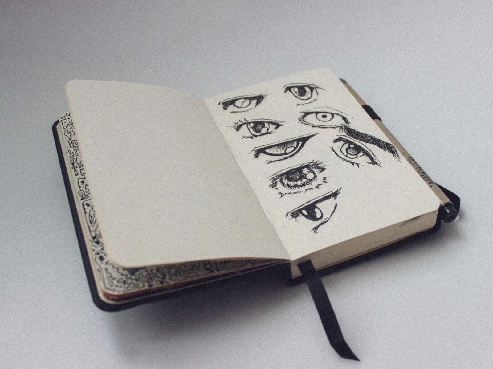 Sketchbook page full of drawn eyes