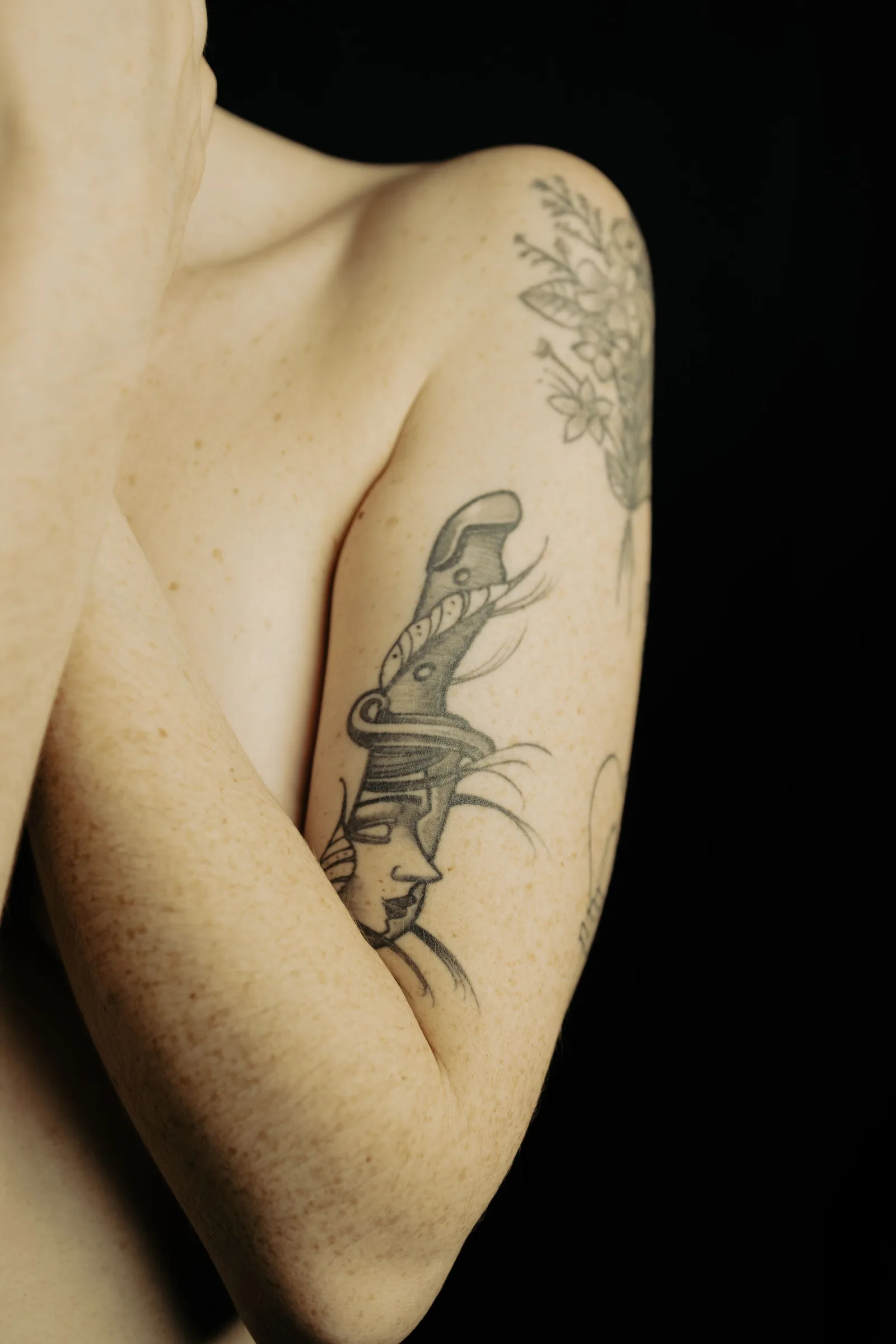Dagger tattoo on an inner arm