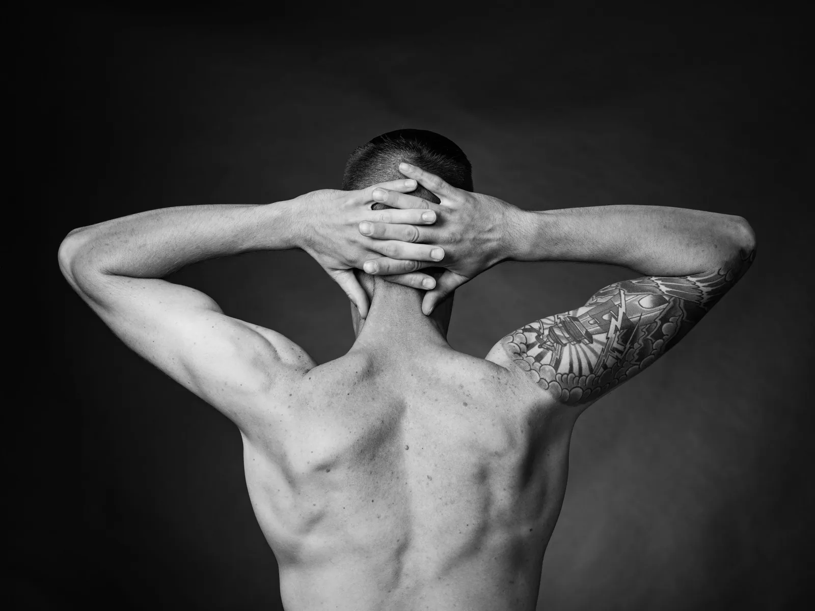 Healed tattoo on an upper arm, seen from the back