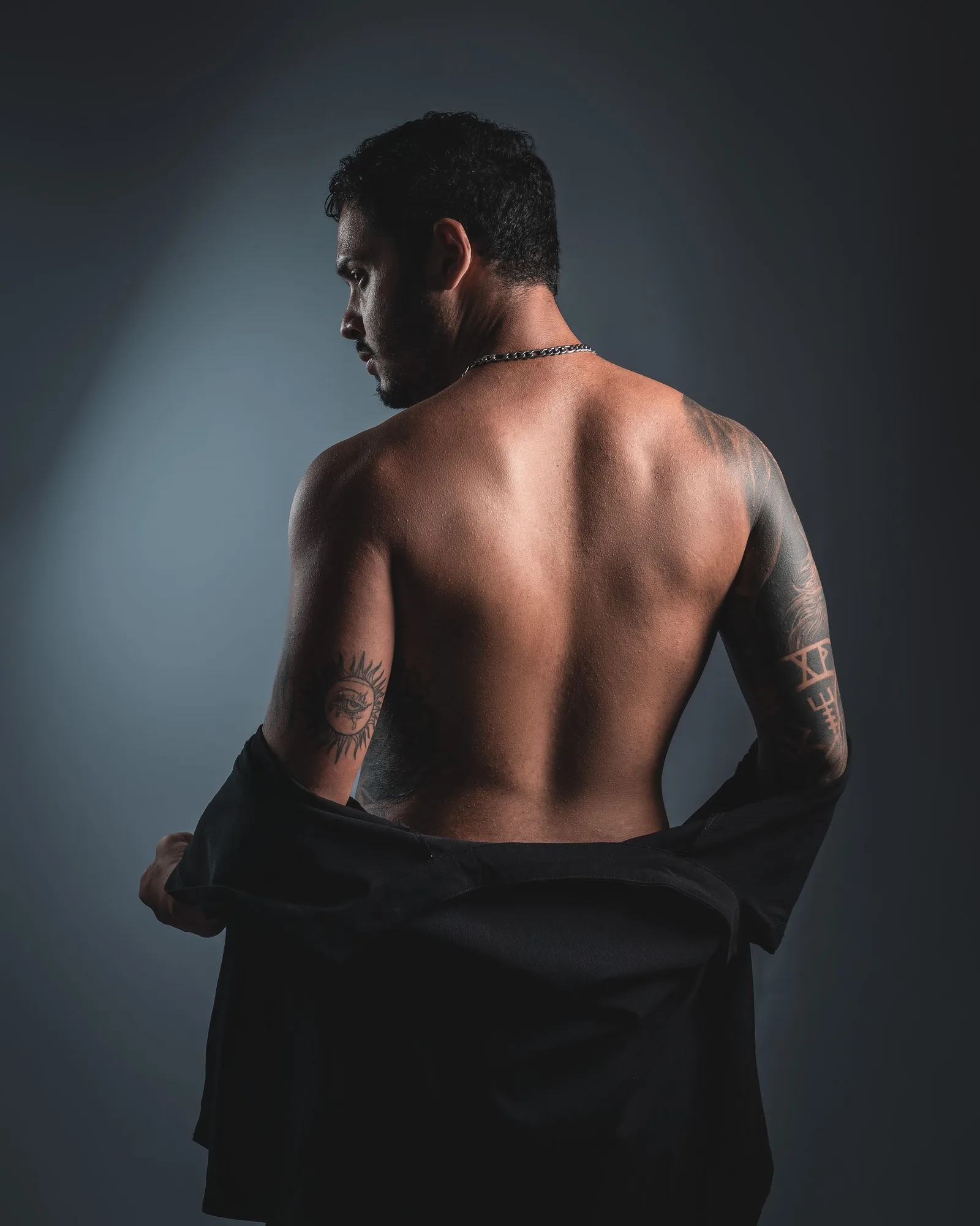 Blackwork across the shoulder and spine of a man