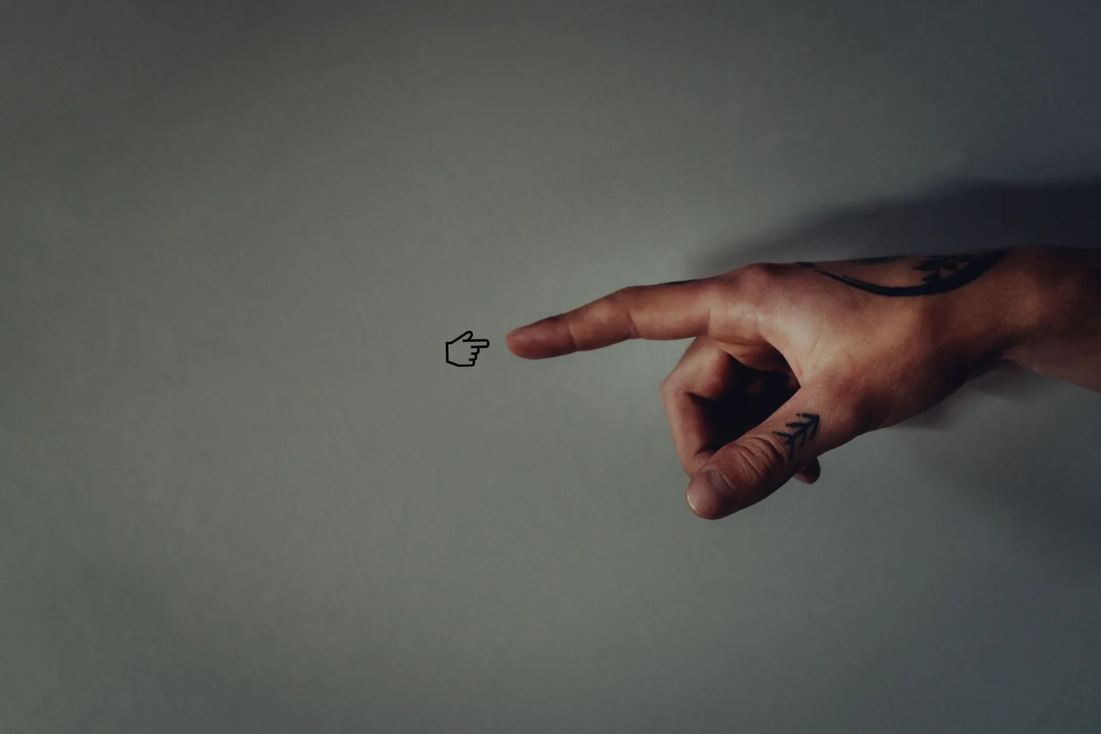 Tiny hand tattoo on a finger