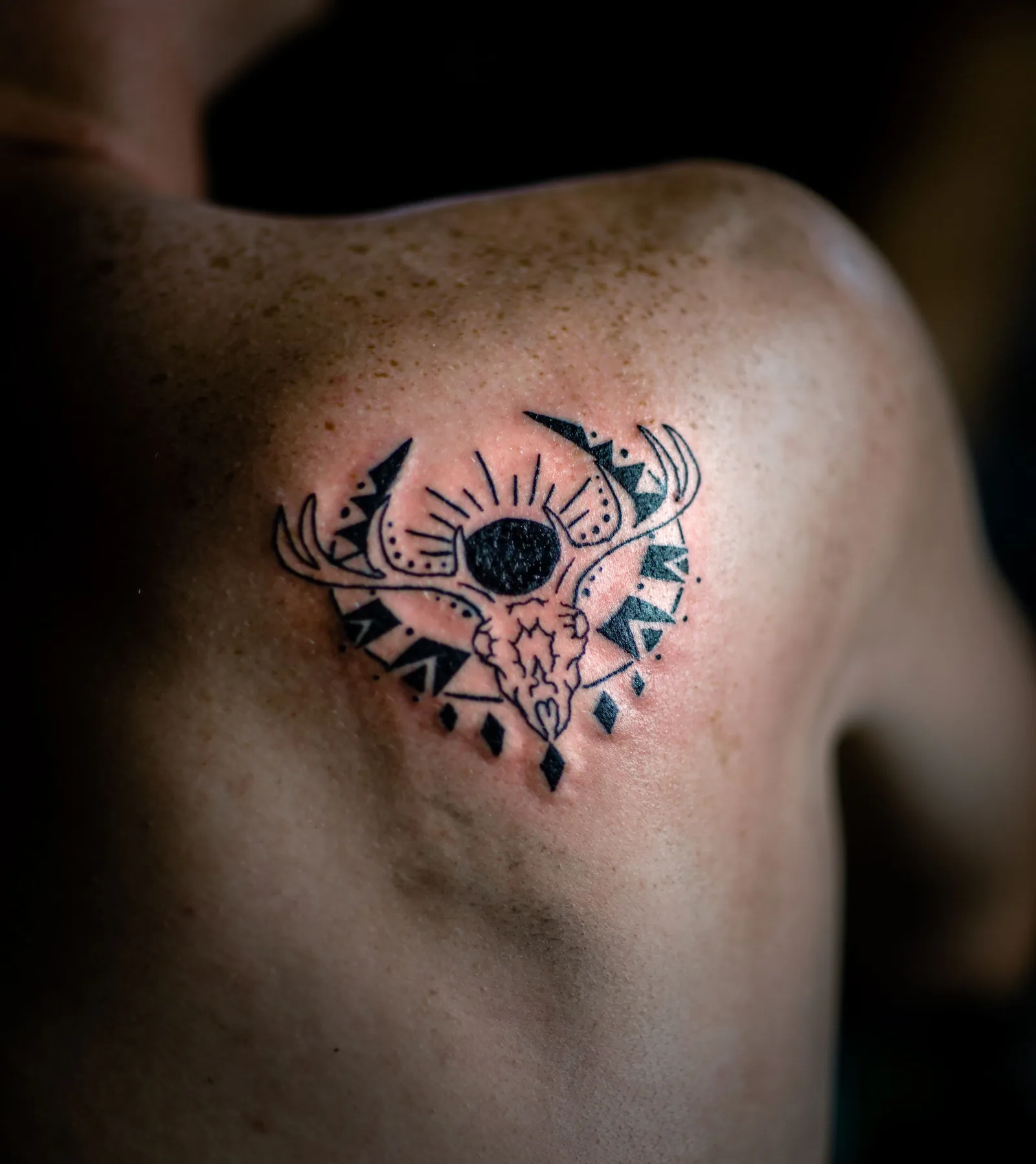 Geometric black tattoo on a shoulder