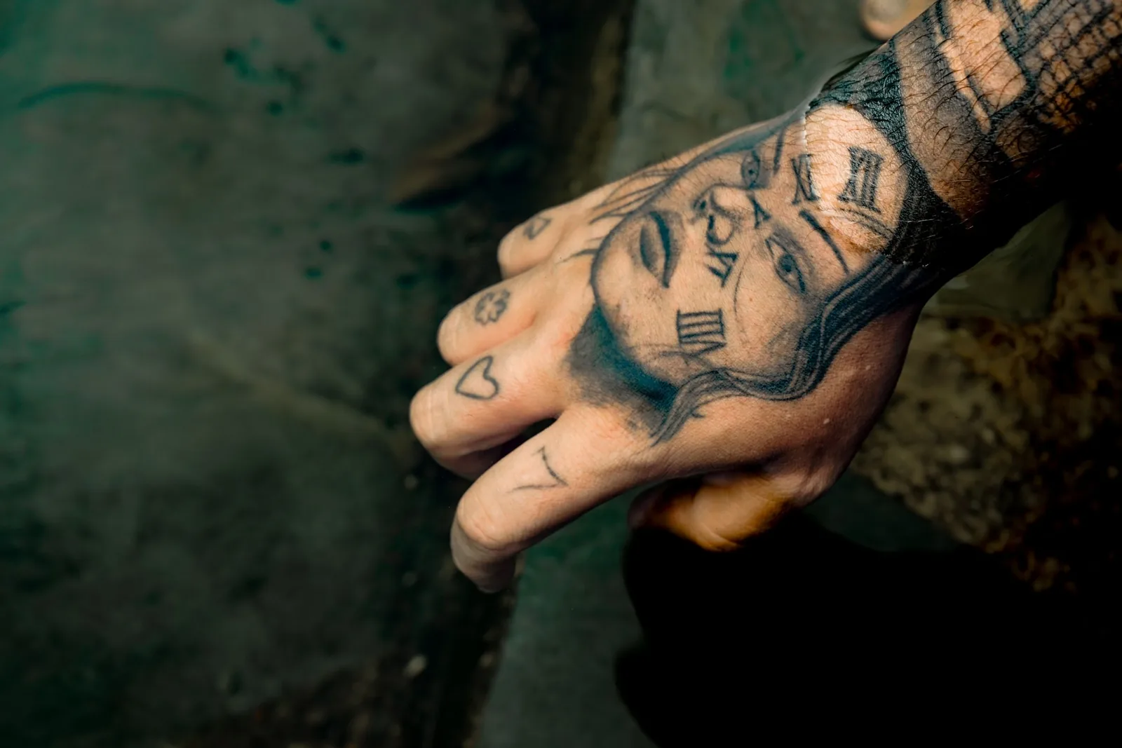 Clock tattoo on the back of a hand