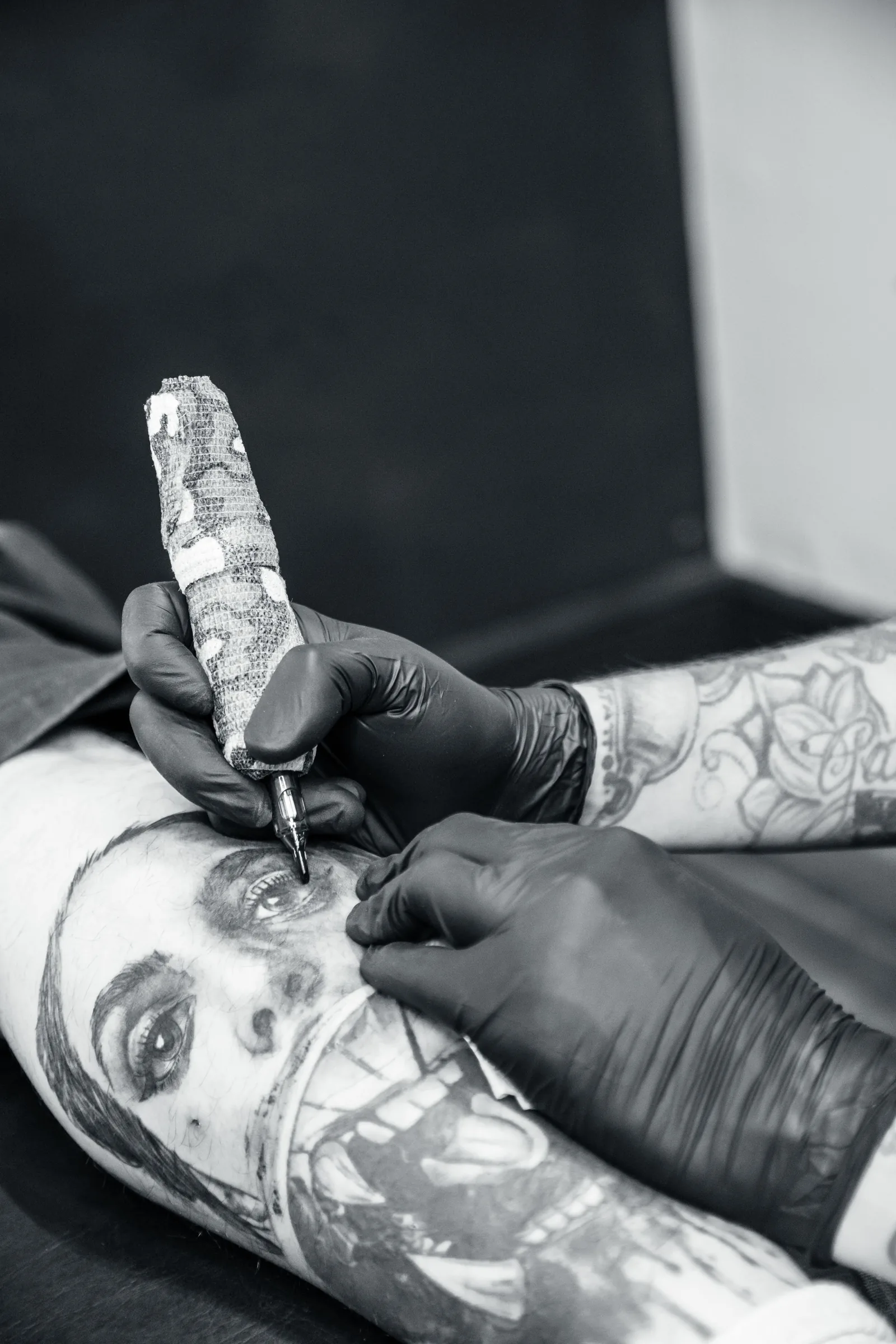 Realistic portrait being tattooed on a leg